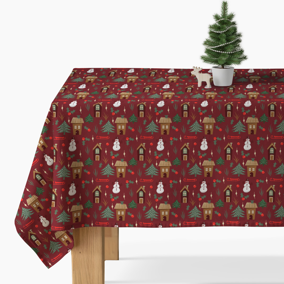 obrus świąteczny czerwony na stole ze świecami i zielenią