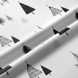 tkanina bieżnika w białym kolorze z czarnym wzorem choinek – zbliżenie