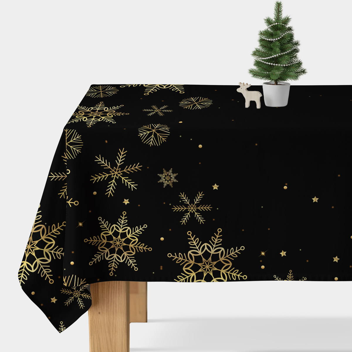elegancki czarny obrus świąteczny ze złotymi płatkami śniegu na stole