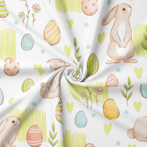 Detal tkaniny – wzór króliczków i pisanek na obrusie wielkanocnym