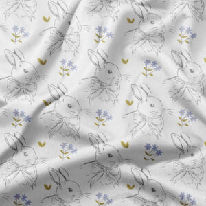 Detal tkaniny – biały obrus wielkanocny z króliczkami