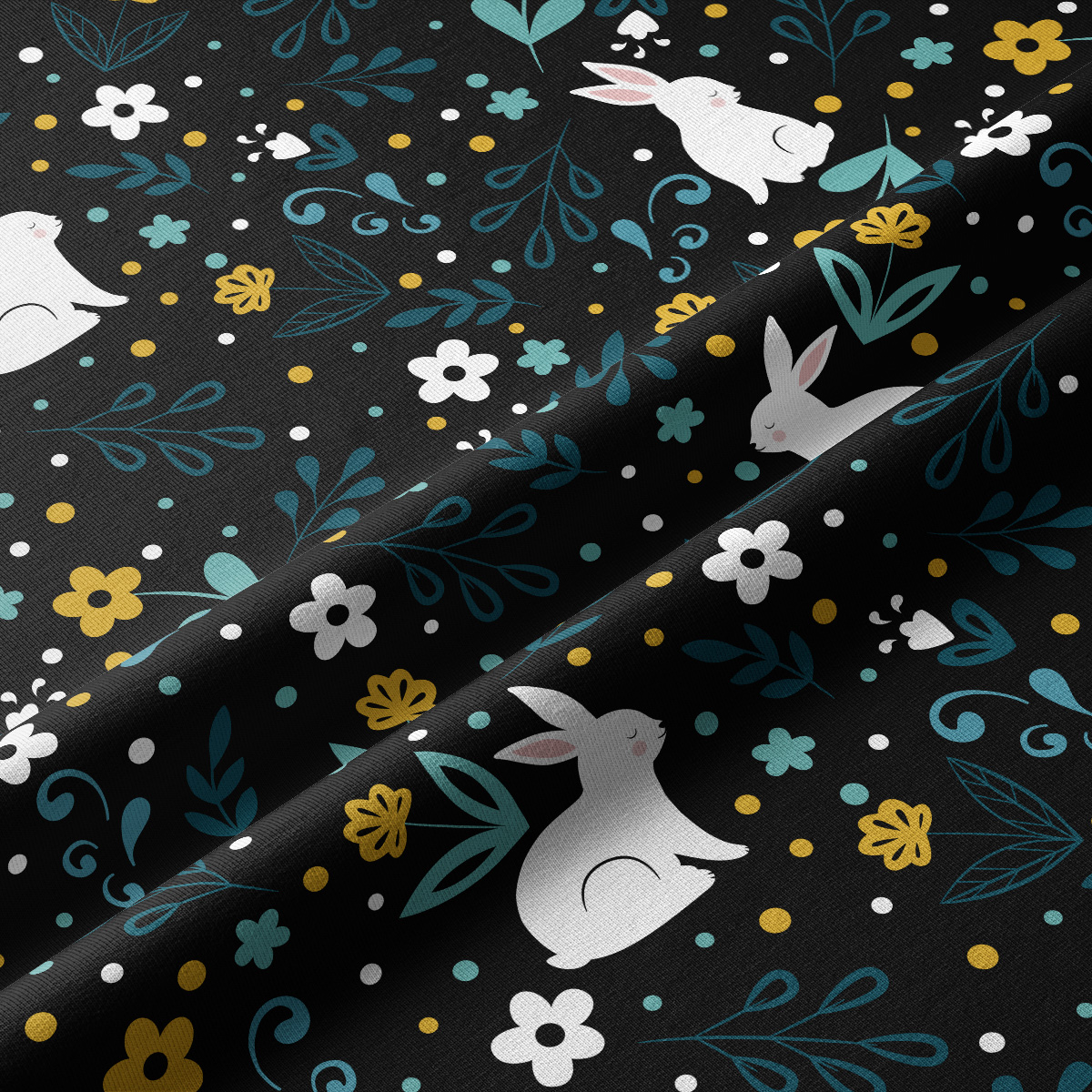 Zbliżenie na fakturę tkaniny i wzór z zajączkami, listkami i drobnymi kropeczkami