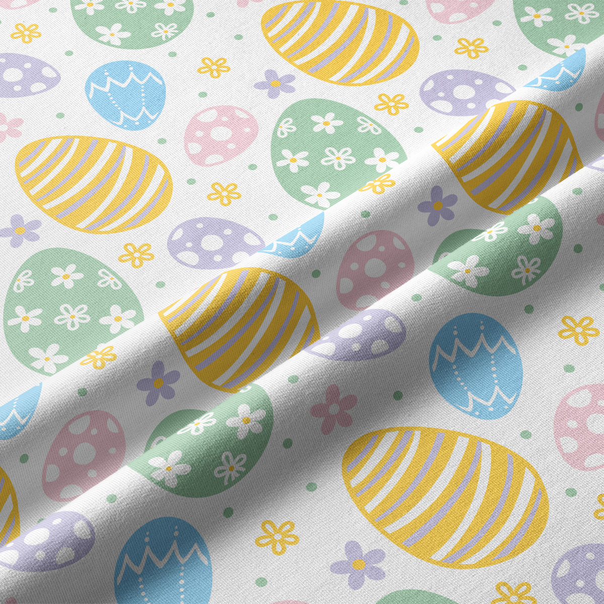 Zbliżenie na tkaninę z nadrukiem pisanek i drobnych kwiatuszków, widoczna faktura materiału