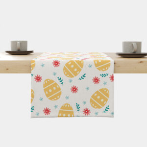 Bieżnik z motywem żółtych pisanek i wiosennych kwiatów rozłożony centralnie na drewnianym stole