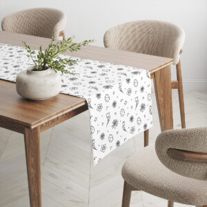 Bieżnik na drewnianym stole z dekoracyjną donicą i widoczną fakturą tkaniny