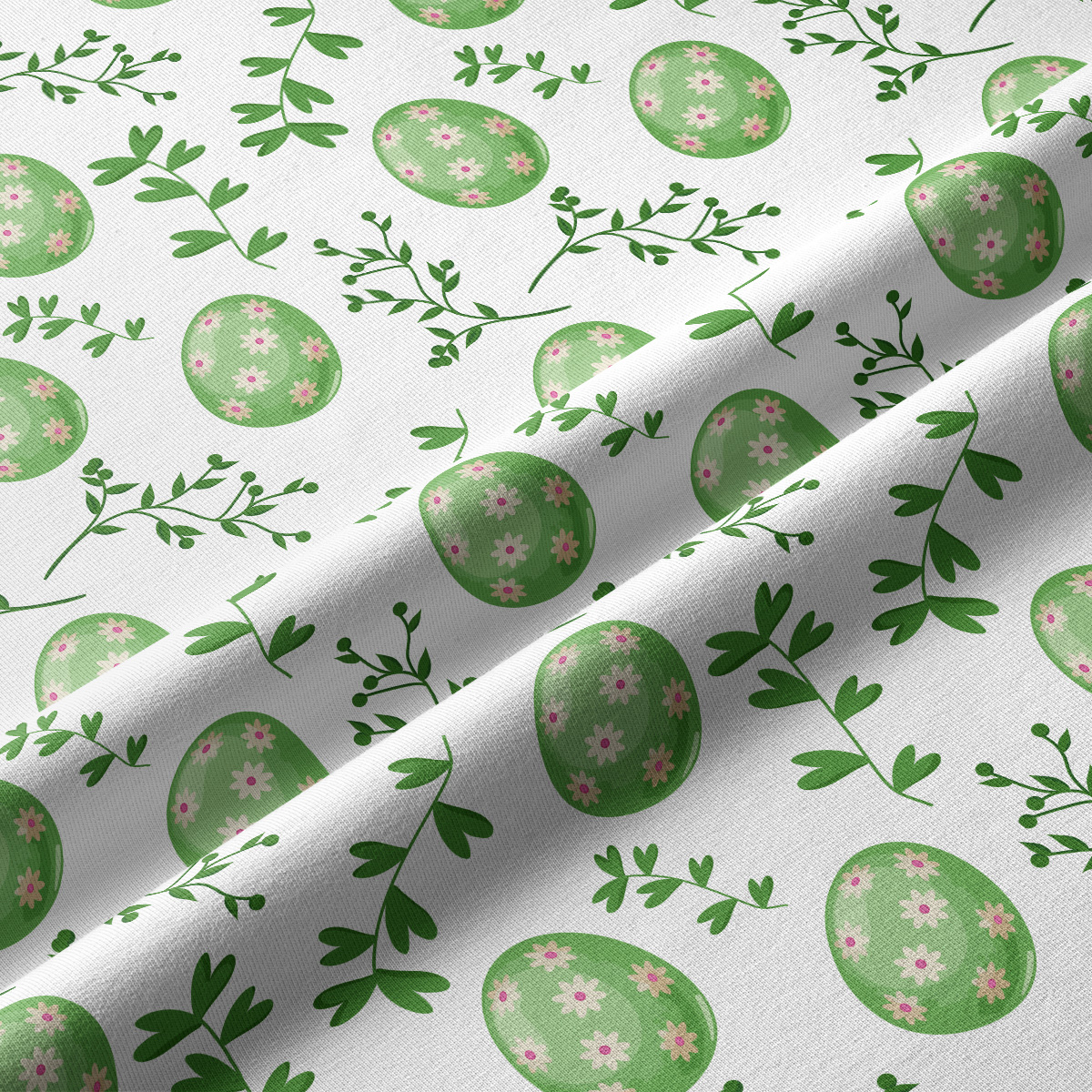 Zbliżenie faktury tkaniny i detali wzoru z zielonymi pisankami i różowymi kwiatuszkami