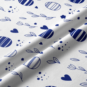 Zbliżenie na fakturę tkaniny i szczegóły nadruku z jajkami, listkami i kropeczkami