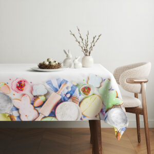 Aranżacja stołu z obrusem, ceramicznymi zajączkami, talerzem z pisklętami i gałązkami wierzbiny dla subtelnej dekoracji