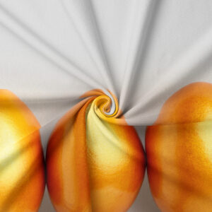 Zbliżenie na fakturę tkaniny i detal nadruku dużego, złotego jajka