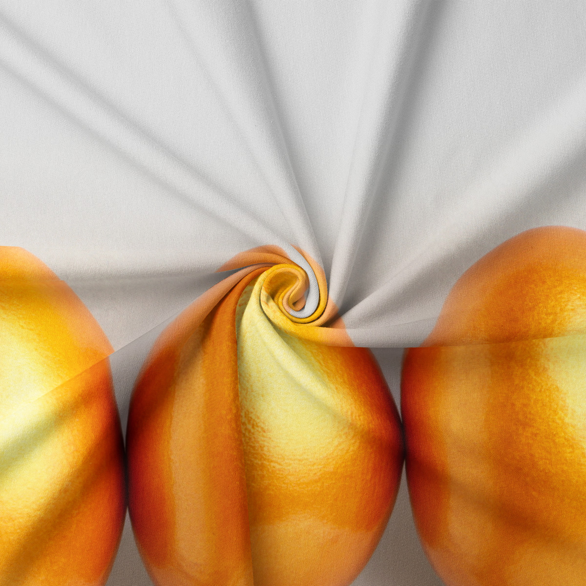 Zbliżenie na fakturę tkaniny i detal nadruku dużego, złotego jajka