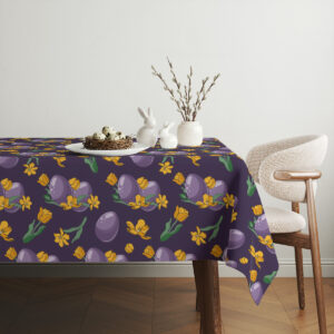 Aranżacja stołu z wielkanocnym koszykiem i dekoracjami położona na obrusu