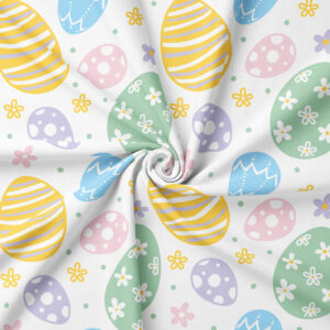 Zbliżenie na fakturę tkaniny i detal wzoru pisanek w pastelowych kolorach