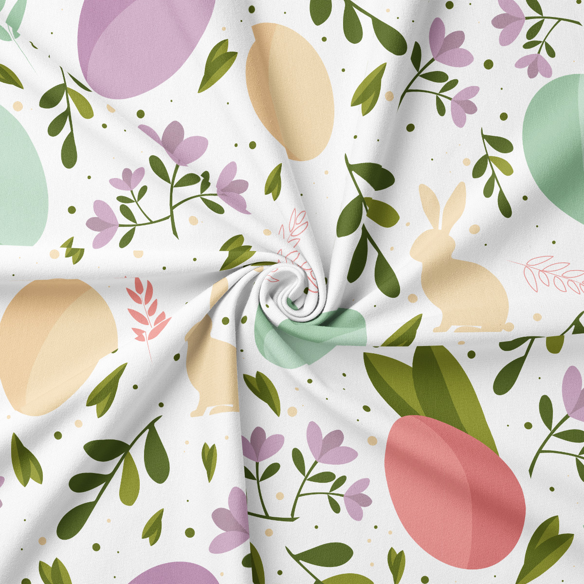 Zbliżenie na tkaninę z motywem pisanek, zajączków i gałązek, widoczna delikatna faktura materiału