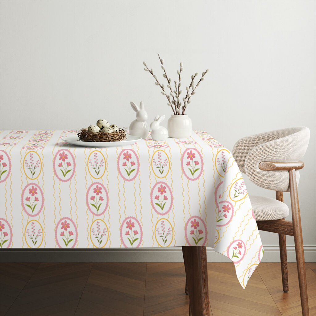 Aranżacja stołu z porcelanowymi zajączkami i gałązkami bazi na obrusie w pastelowe pisanki