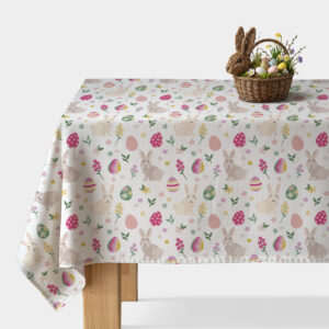 Obrus na stole z pastelowym wzorem króliczków i pisanek, widok ogólny z koszykiem wielkanocnym