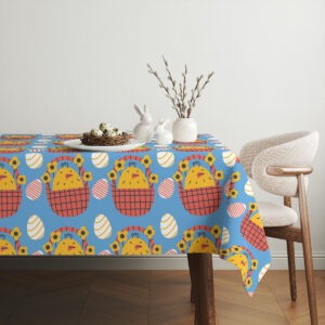 Aranżacja stołu z obrusem, ceramiczne figurki króliczków i gałązki bazi tworzą świąteczny nastrój