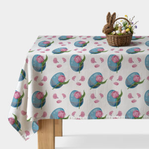 Obrus z wzorem niebieskich pisanek i różowych tulipanów na stole, ujęcie z koszykiem wielkanocnym ustawionym na rogu