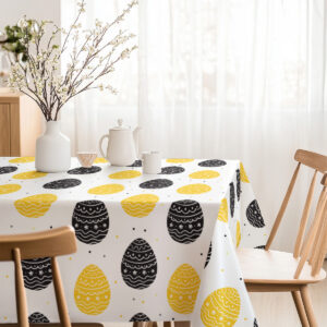 Jasne, przytulne nakrycie stołu z motywem pisanek i prostą zastawą do śniadania