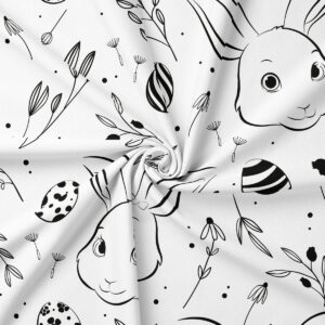 Zbliżenie na wzór obrusa z ręcznie rysowanymi króliczkami, pisankami i delikatnymi listkami