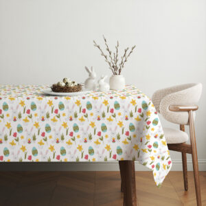 aranżacja stołu z dekoracjami wielkanocnymi i obrus z pastelowymi motywami