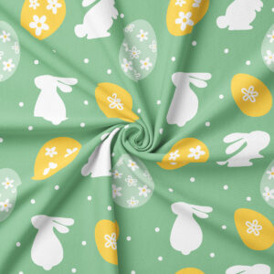 Zbliżenie na wzór z białymi sylwetkami zajączków, żółtymi i jasnymi pisankami oraz drobnymi kropeczkami