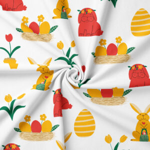 Zbliżenie tkaniny z powtarzającym się wzorem zajączków, gniazd i tulipanów w żółto-czerwonej kolorystyce