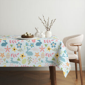 Aranżacja stołu z obrusem i wiosenną dekoracją z gałązkami oraz ceramicznymi zajączkami