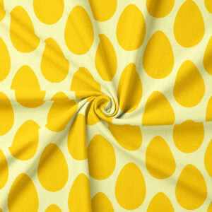 zbliżenie na tkaninę z powtarzającym się motywem żółtych jajek i widoczną fakturą materiału