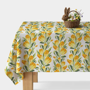 Obrus z żółtymi tulipanami na białym tle z koszykiem wielkanocnym na rogu stołu