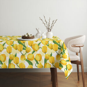 Aranżacja stołu z obrusem, ceramicznymi zajączkami i gałązkami bazi