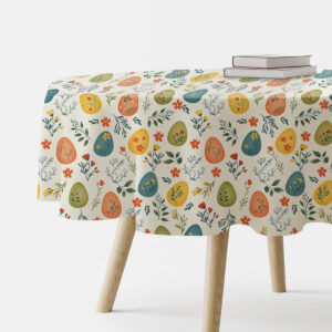okrągły obrus z pastelowymi pisankami i gałązkami na stole, ujęcie boczne