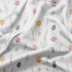 zbliżenie na tkaninę z delikatnym wzorem pisanek, kwiatów i gałązek w pastelowych kolorach