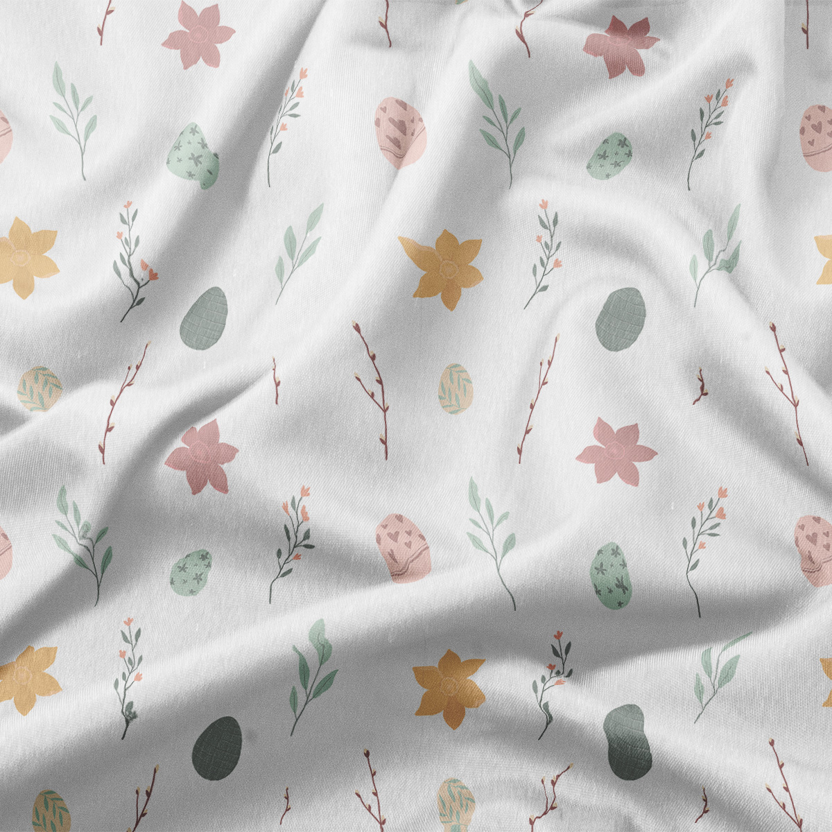 zbliżenie na tkaninę z delikatnym wzorem pisanek, kwiatów i gałązek w pastelowych kolorach