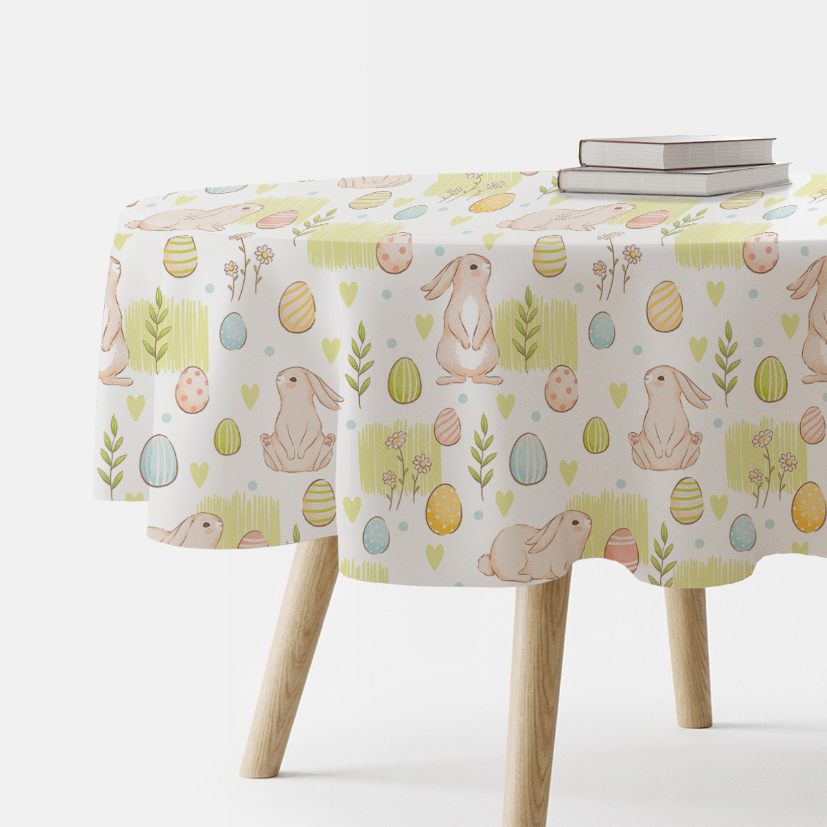 okrągły obrus z motywem wielkanocnych króliczków i pisanek na stole z drewnianymi nogami