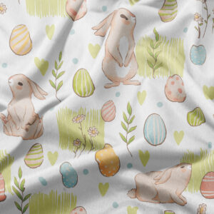 zbliżenie na tkaninę z akwarelowym wzorem króliczków, pisanek i zielonych akcentów