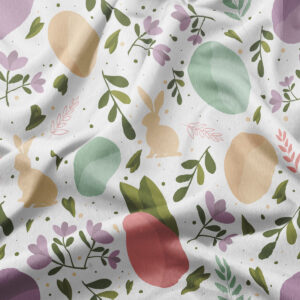 Zbliżenie na fakturę materiału i detale nadruku z jajkami, zajączkami i liśćmi w pastelowych kolorach