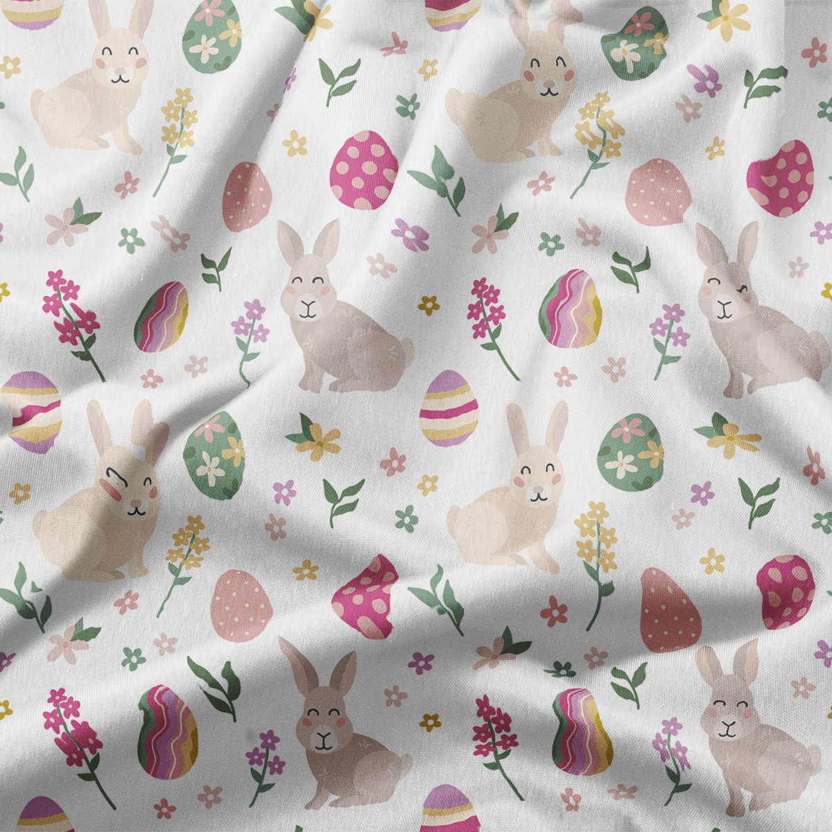 Zbliżenie na tkaninę z motywem zajączków, kolorowych pisanek i drobnych kwiatów