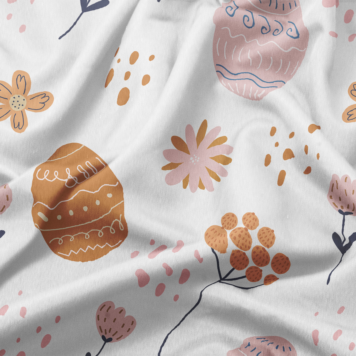 Zbliżenie tkaniny pokazujące detale nadruku pisanek, kwiatów i nieregularnych kropek