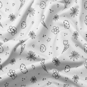 Zbliżenie na tkaninę z ręcznie rysowanymi motywami pisanek, tulipanów i drobnych kwiatów