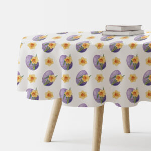 Okrągły obrus z motywem fioletowych pisanek i żółtych żonkili na stole w aranżacji z książkami