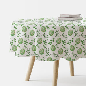 okrągły obrus z motywem zielonych pisanek i gałązek na stole, ujęcie boczne z książkami