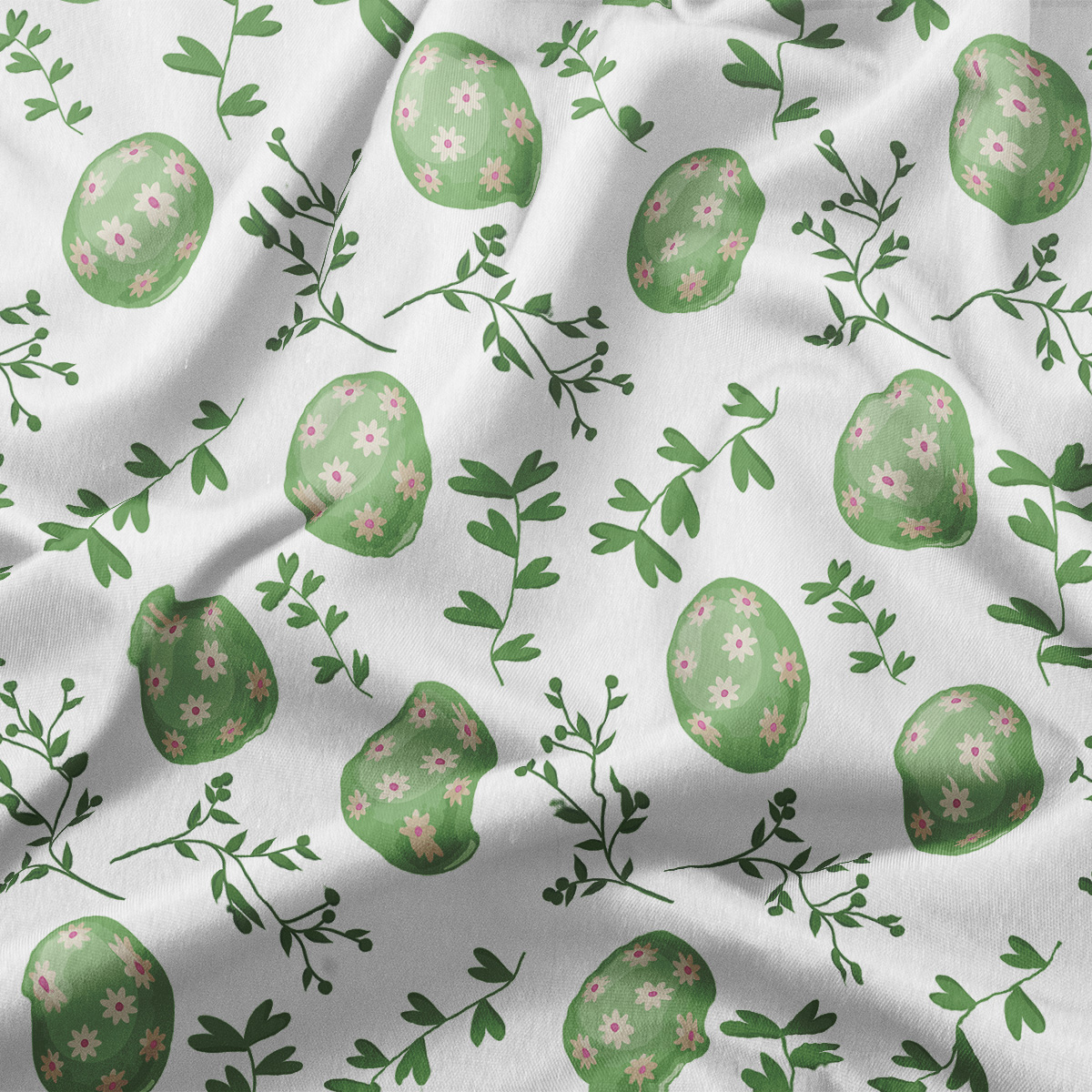 zbliżenie na fakturę tkaniny i detale nadruku z zielonymi pisankami i małymi różowymi kwiatkami