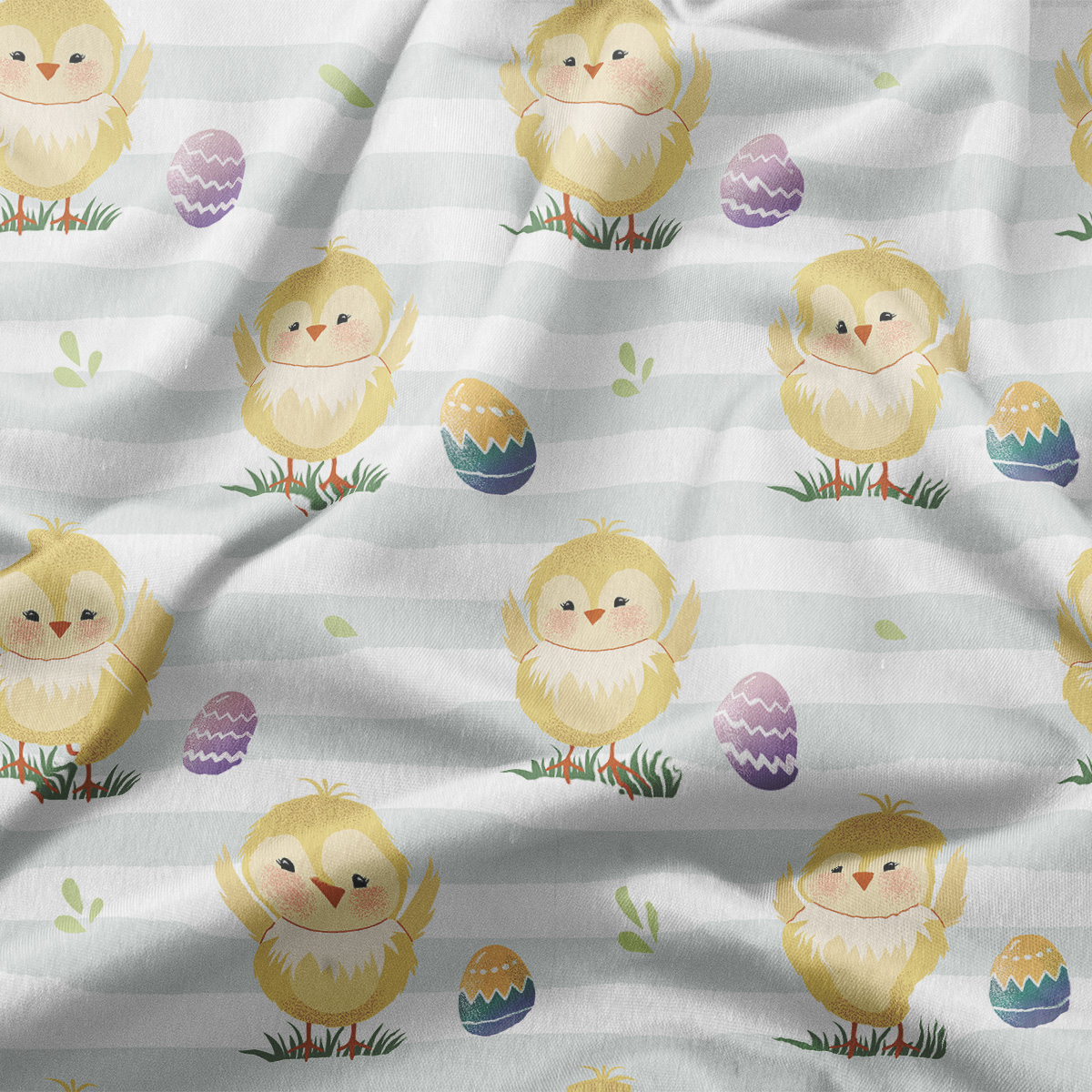 Zbliżenie na fakturę tkaniny i szczegóły nadruku z kurczaczkami i pisankami