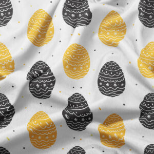 Zbliżenie na wzór pisanek i strukturę tkaniny z widocznymi żółtymi i czarnymi elementami oraz drobnymi kropkami