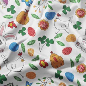 Zbliżenie na wzór obrusy pokazujące kurczaczki, pisanek i zielone listki na jasnym tle