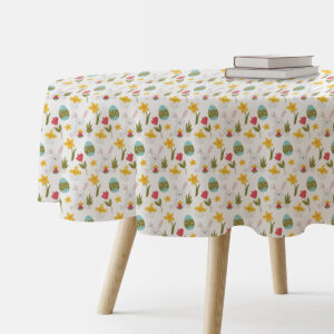 Okrągły obrus z motywem wielkanocnych zajączków i pisanek na białym tle, ujęcie stołu z boku z książkami na blacie