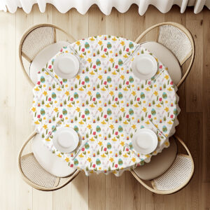 Widok z góry na okrągły stół przykryty obrusem z motywem wielkanocnym z ustawioną zastawą