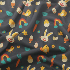 Zbliżenie na fakturę tkaniny i kolorowe ilustracje piskląt, jajek, marchewek oraz tęczy