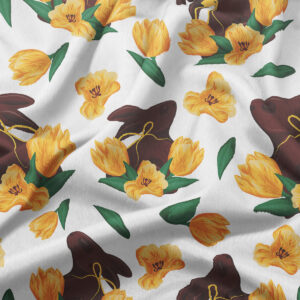 Zbliżenie na tkaninę z nadrukiem czekoladowych zajączków i żółtych tulipanów, detal kolorów i wzoru