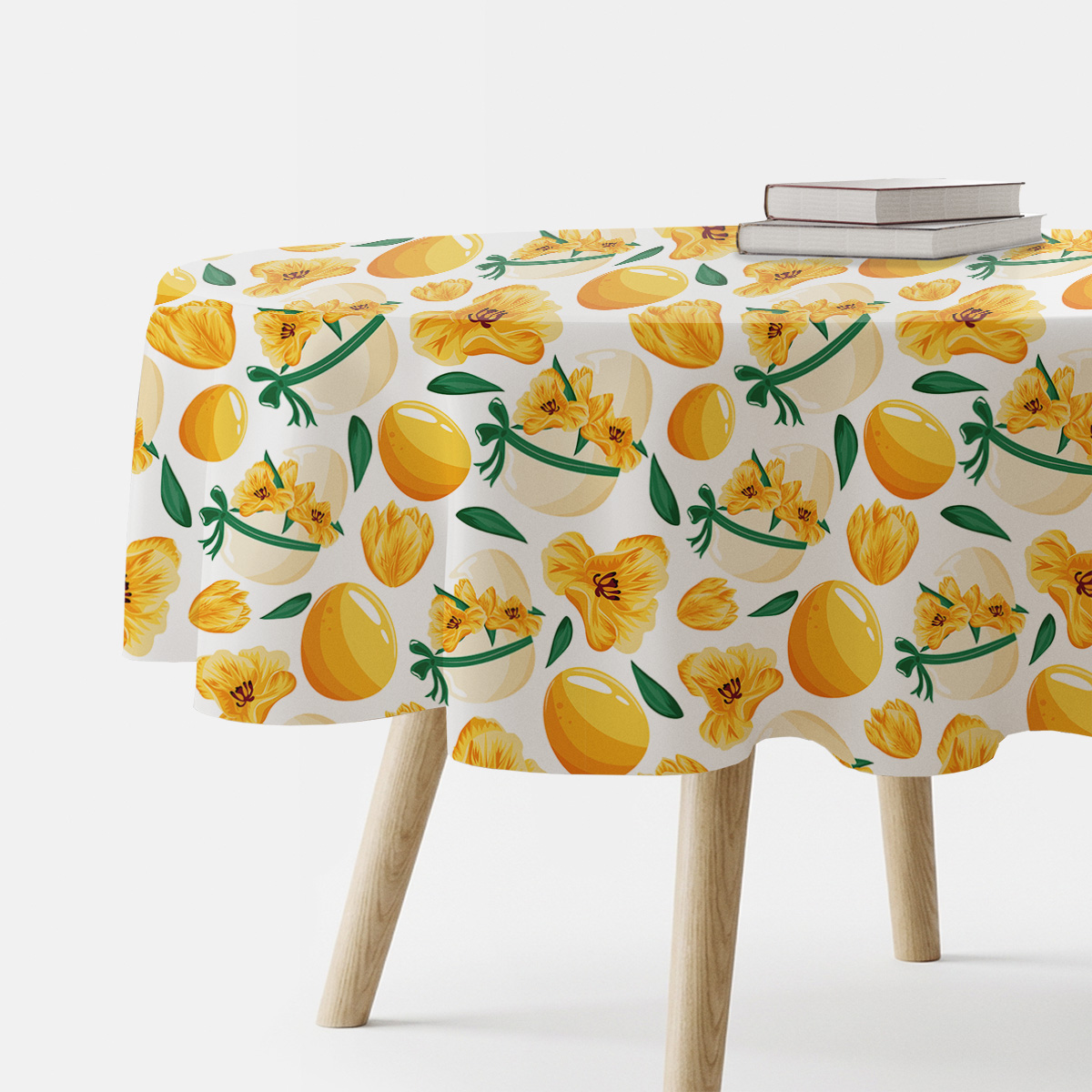 Okrągły obrus z motywem żółtych pisanek i wiosennych kwiatów na stoliku